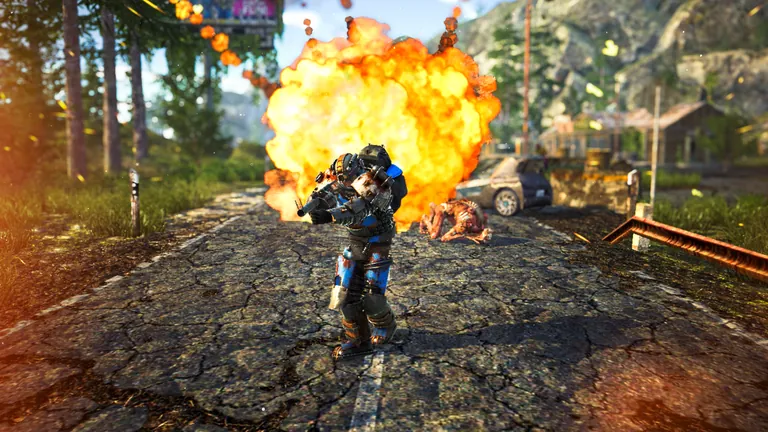 A survivor in armor runs from an explosion on a broken forest road.